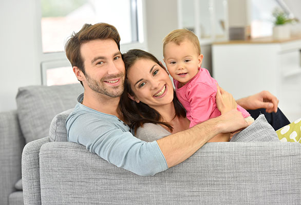 Couple with baby girl enjoying family time at home